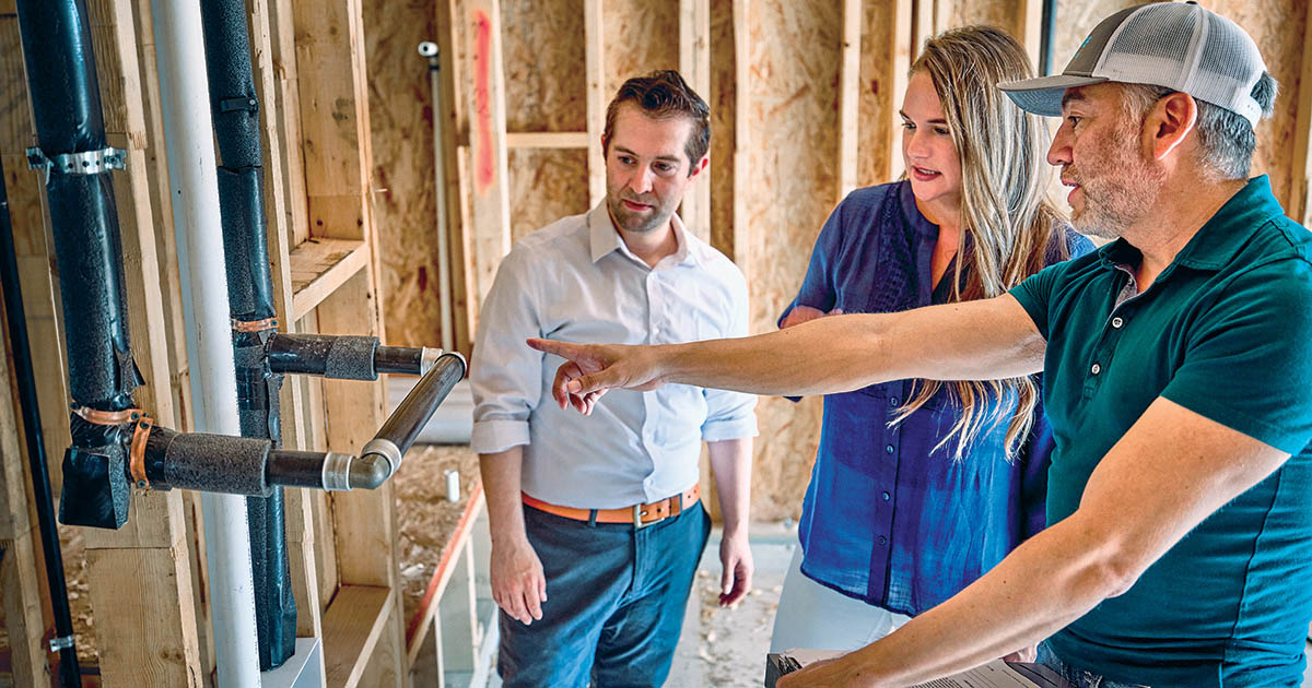 couple and builder at job site